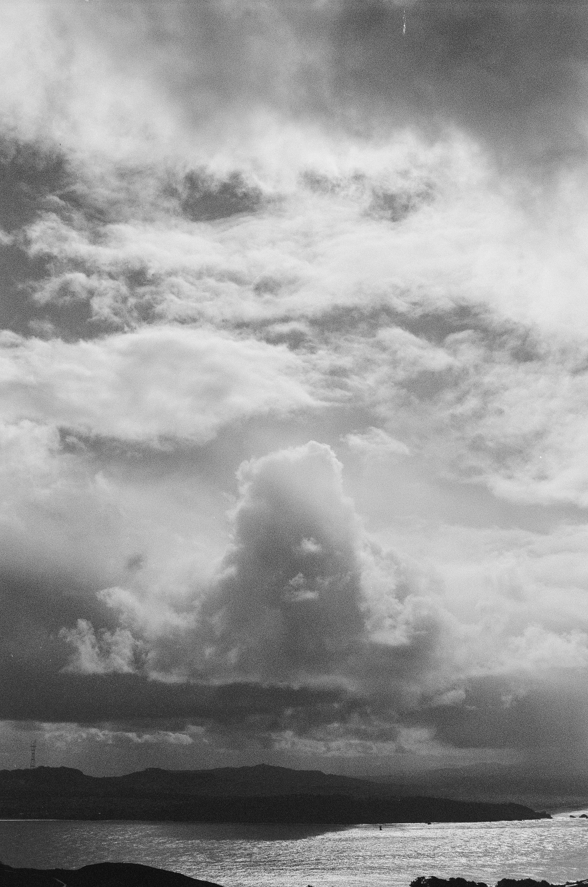 Moody clouds above the water in black and white.