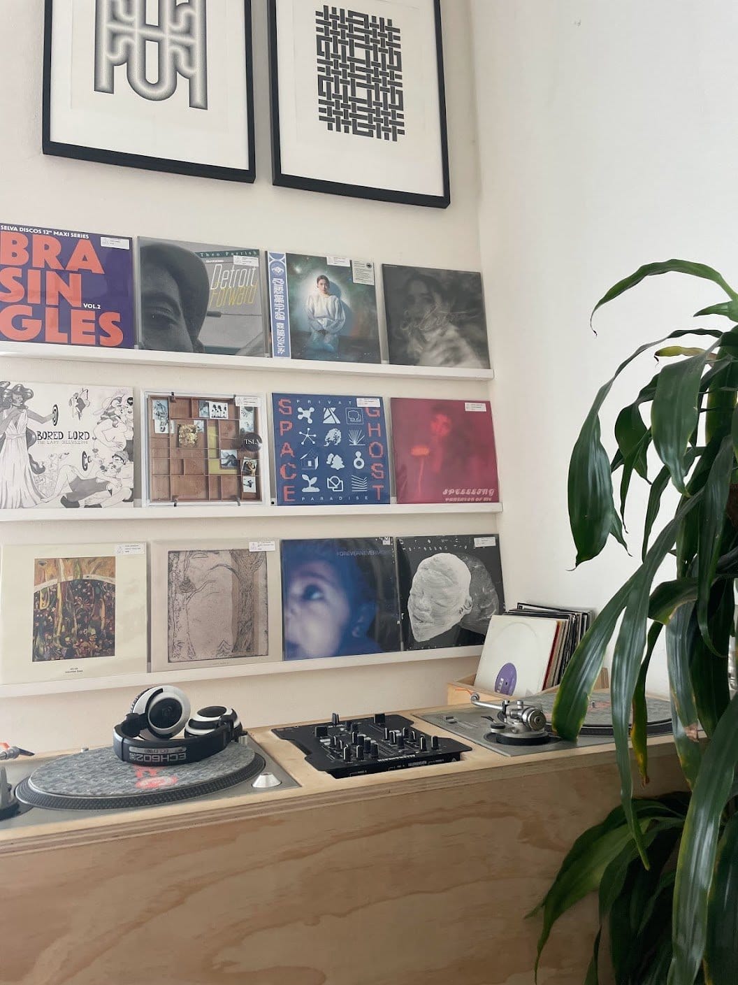 A custom-built DJ booth in front of records for sale on the back wall.